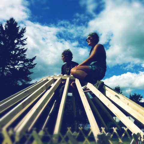 Taking a break atop the roof ring to demonstrate the strength and integrity of the yurt frame. Yestermorrow Yurt Design/Build 2012