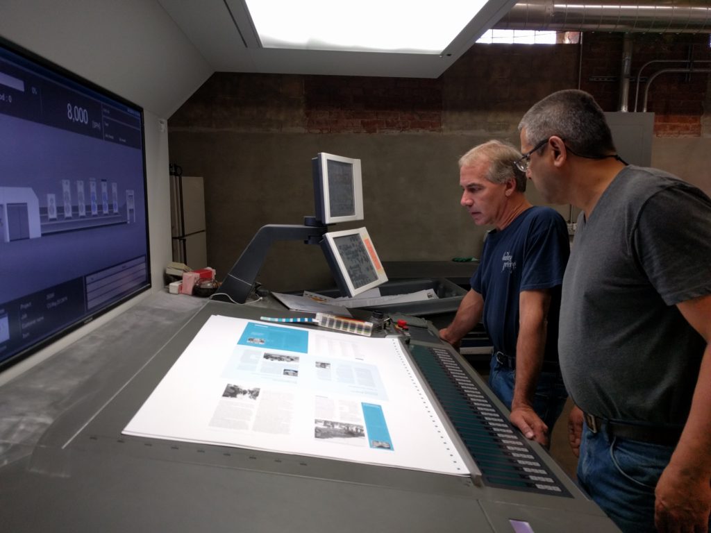 The Hadley Printing press team reviews the quality of a set of pages from this issue.