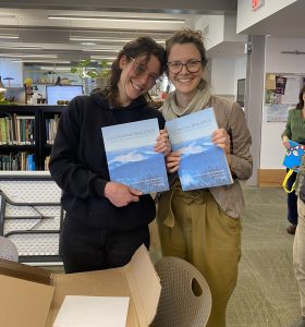 Two Conway students holding their finished project documents.