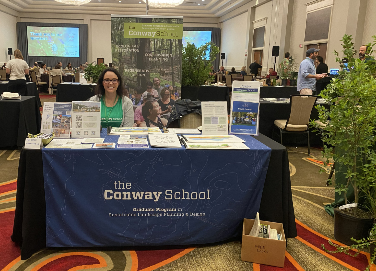 Conway employee sitting at an exhibitor table during the ELA conference.